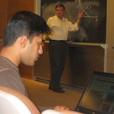 Sid checking the experiment server while in one of Clarks lectures